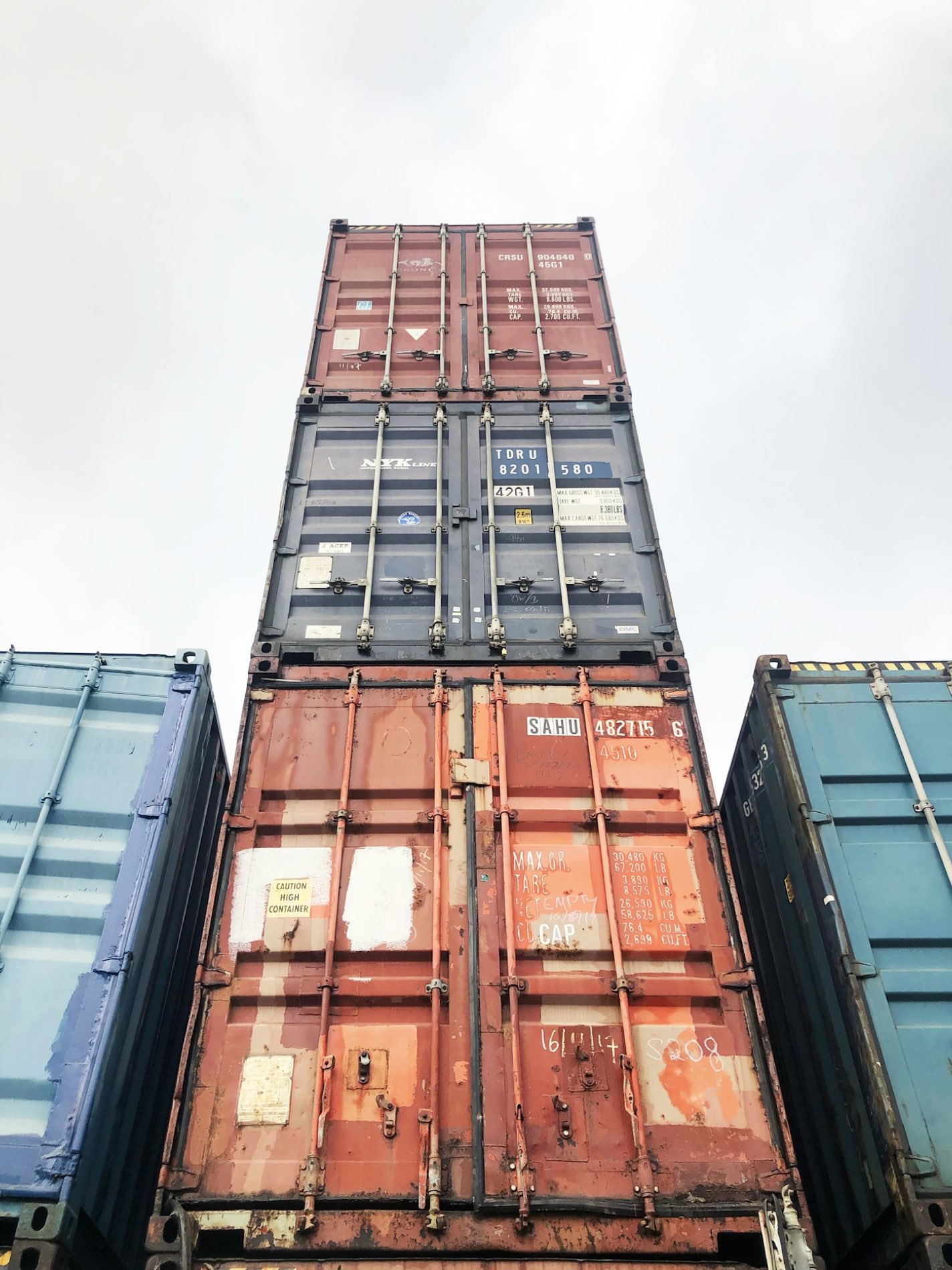 Stacked shipping containers seen from below